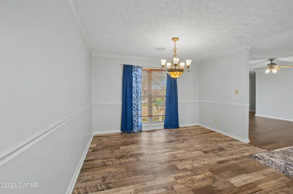 a view of a chandelier in big room and a chandelier
