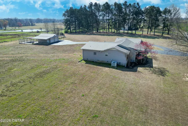 a backyard of a house with lots of green space and fountain