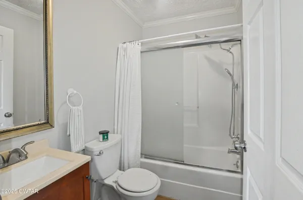 a bathroom with a shower a toilet and sink