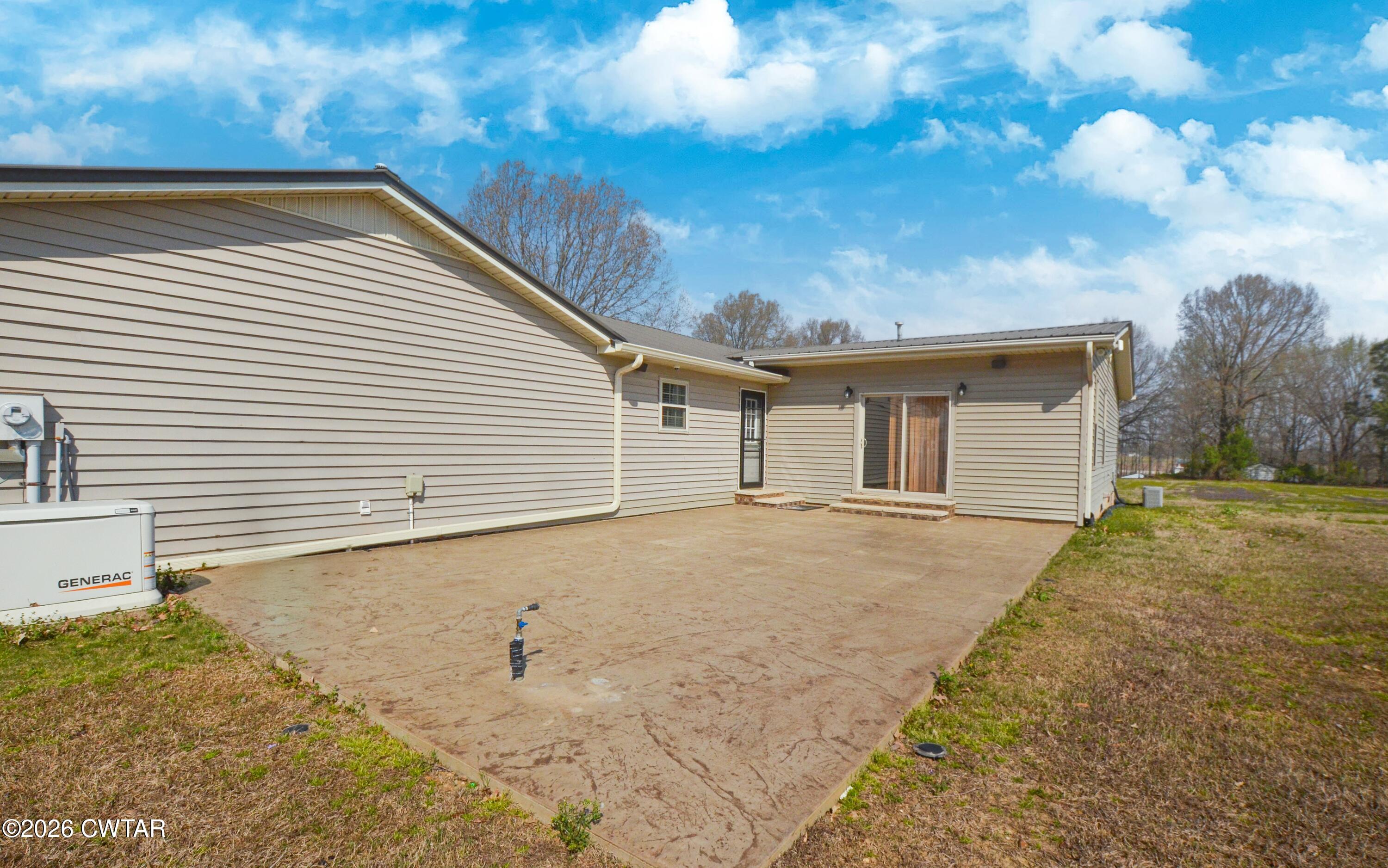 593 Sunny Hill Road Alamo, TN 38001 - Photo 6 of 29 a backyard of a house with large trees