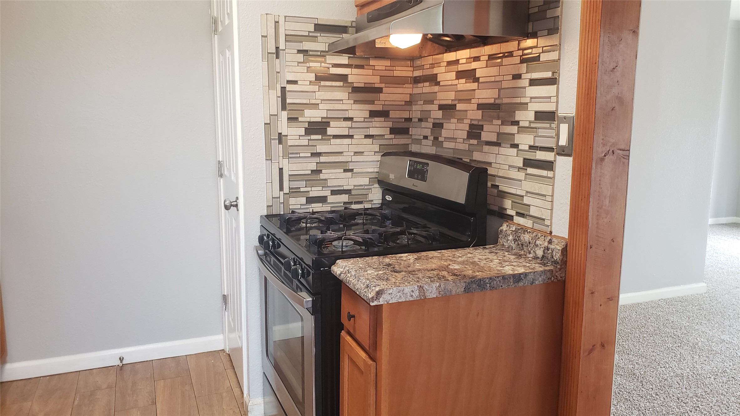 a kitchen with granite countertop a stove and a sink
