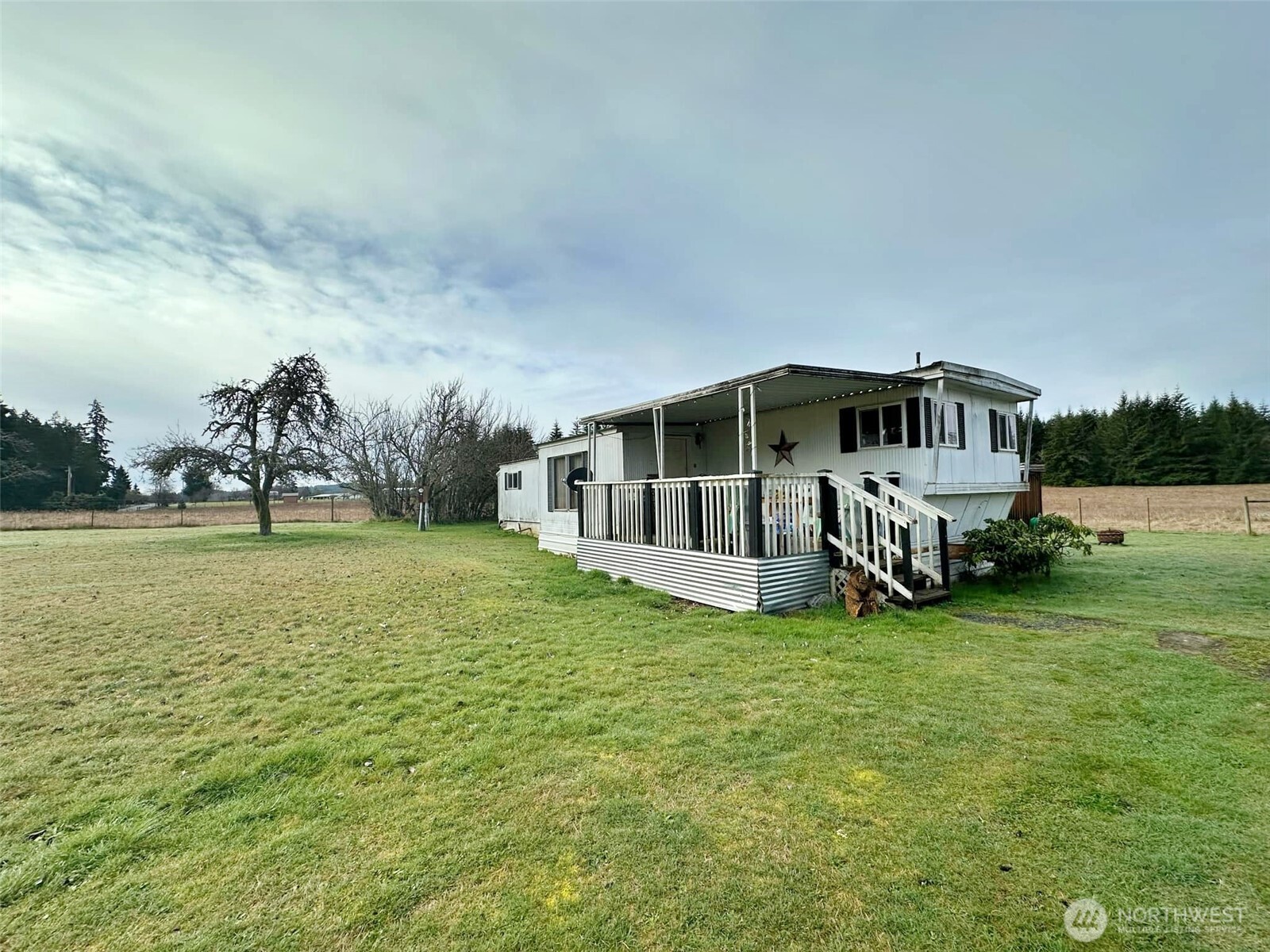 338 Berry Road Chehalis, WA 98532 - Photo 1 of 11 a white house with a big yard and large trees