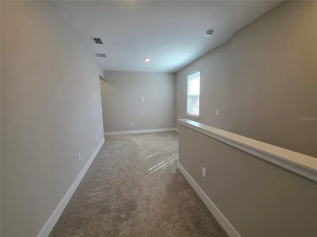 an empty room with a empty space and windows