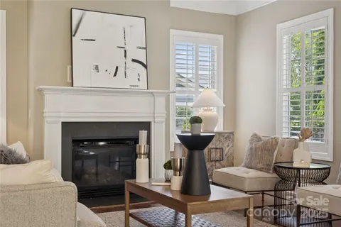 a living room with furniture a window and a fireplace