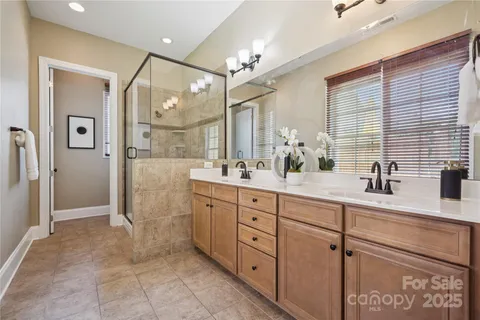 a spacious bathroom with a shower sink and mirror