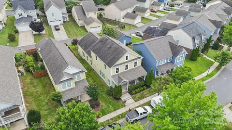 an aerial view of residential house with outdoor space and swimming pool