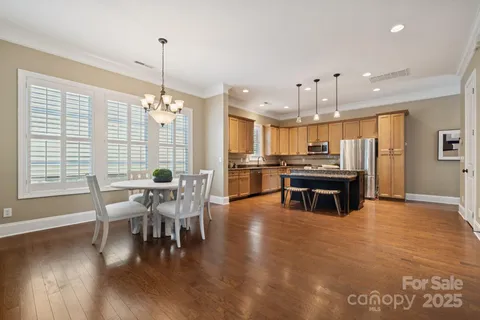 a dining room with furniture and wooden floor