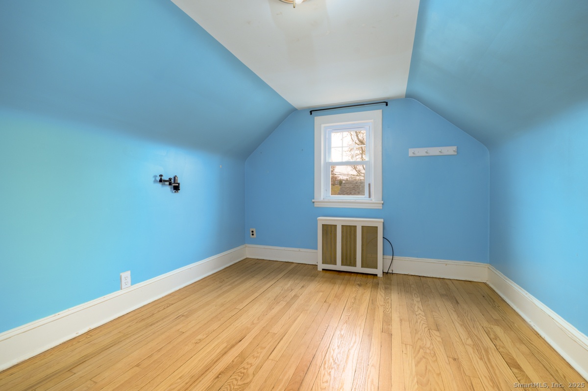 279 Knapps Highway Fairfield, CT 06825 - Photo 15 of 24 an empty room with wooden floor and windows
