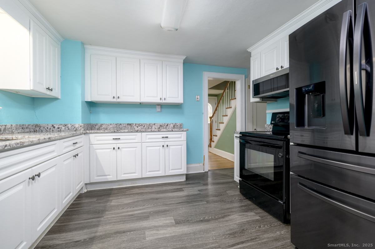 279 Knapps Highway Fairfield, CT 06825 - Photo 7 of 24 a kitchen with a sink stove and refrigerator
