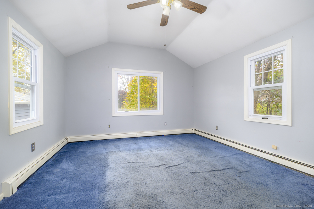 279 Knapps Highway Fairfield, CT 06825 - Photo 8 of 24 a view of an empty room with a window and wooden floor