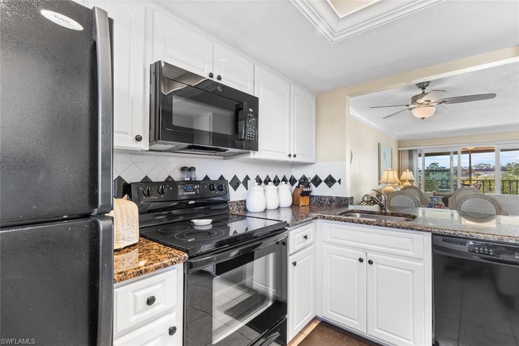 1004 Manatee Road, Unit H306 Naples, FL 34114 - Photo 11 of 48 a kitchen with a sink stove and cabinets