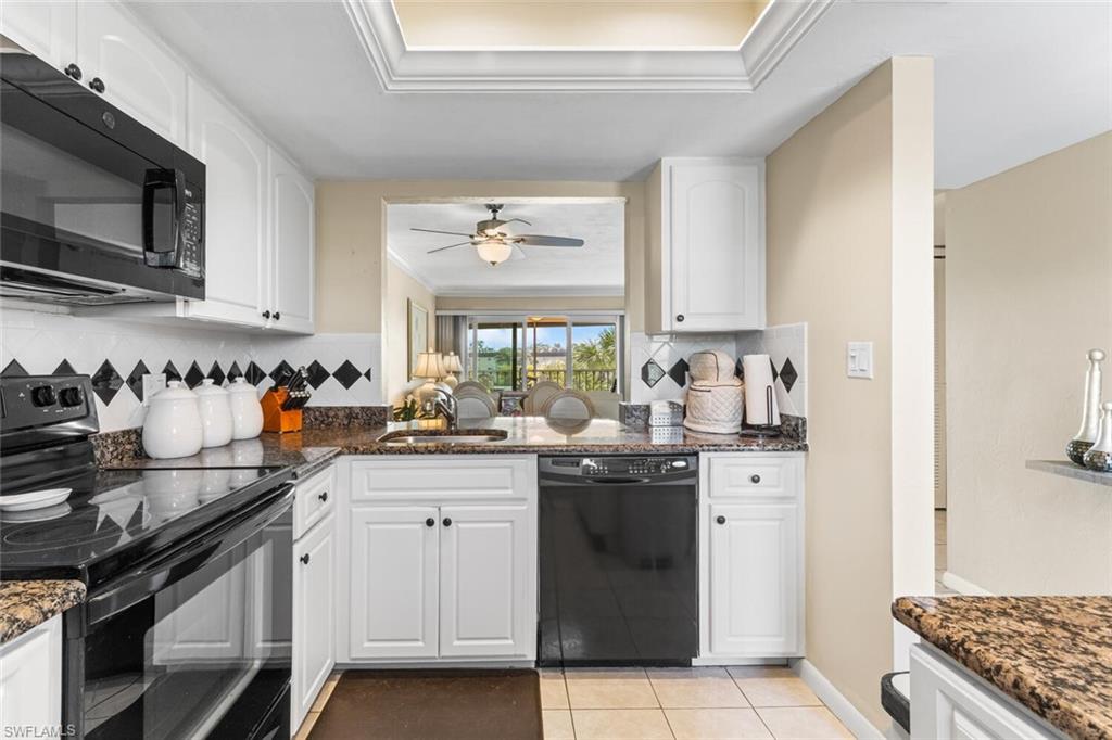 1004 Manatee Road, Unit H306 Naples, FL 34114 - Photo 12 of 48 a kitchen with stainless steel appliances a sink stove and cabinets