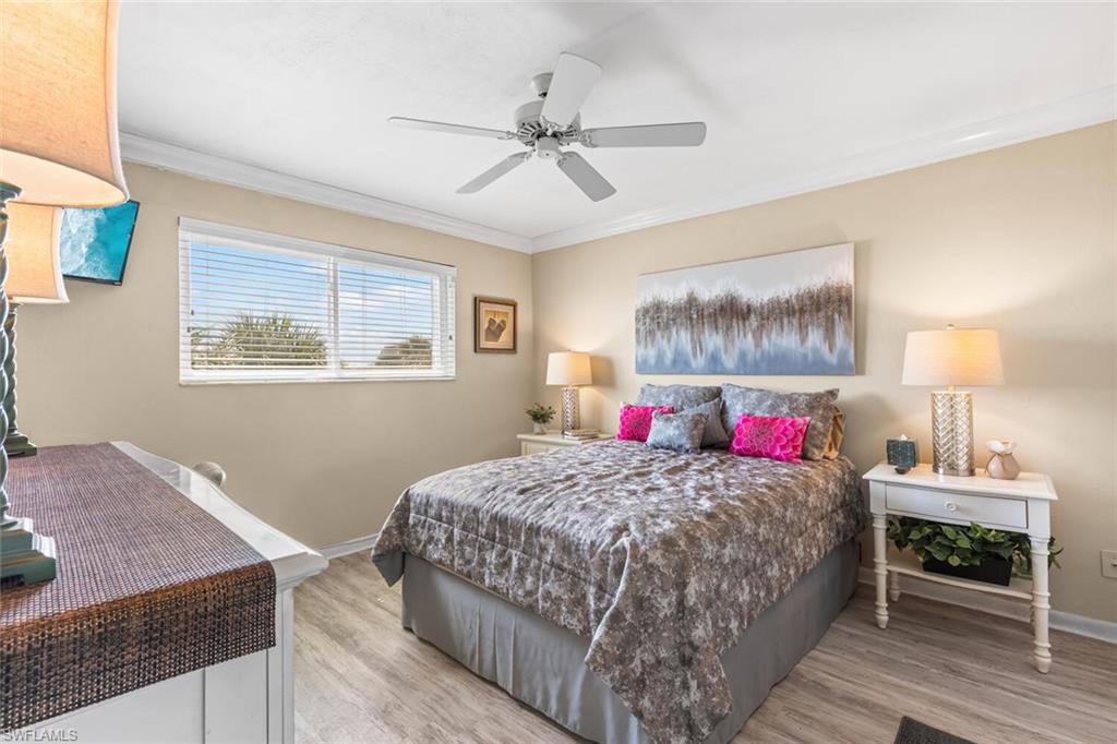 1004 Manatee Road, Unit H306 Naples, FL 34114 - Photo 14 of 48 a bedroom with a bed and a dresser
