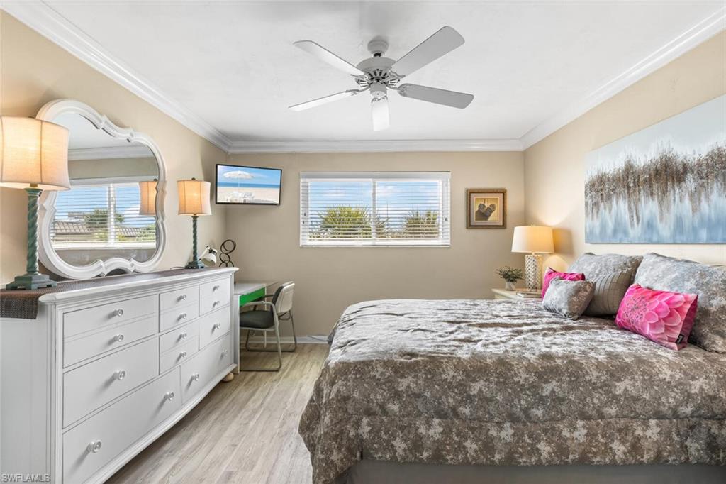 1004 Manatee Road, Unit H306 Naples, FL 34114 - Photo 15 of 48 a bedroom with a large bed and a chandelier