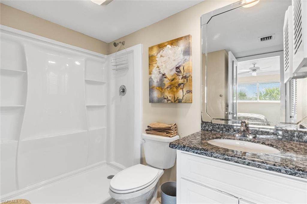 1004 Manatee Road, Unit H306 Naples, FL 34114 - Photo 19 of 48 a bathroom with a granite countertop sink toilet and painting on the wall