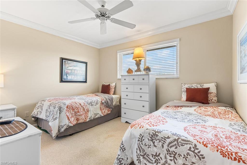 1004 Manatee Road, Unit H306 Naples, FL 34114 - Photo 20 of 48 a bedroom with a bed and a chandelier