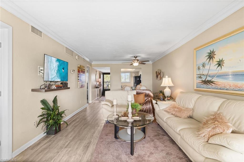 1004 Manatee Road, Unit H306 Naples, FL 34114 - Photo 2 of 48 a living room with furniture and a large window
