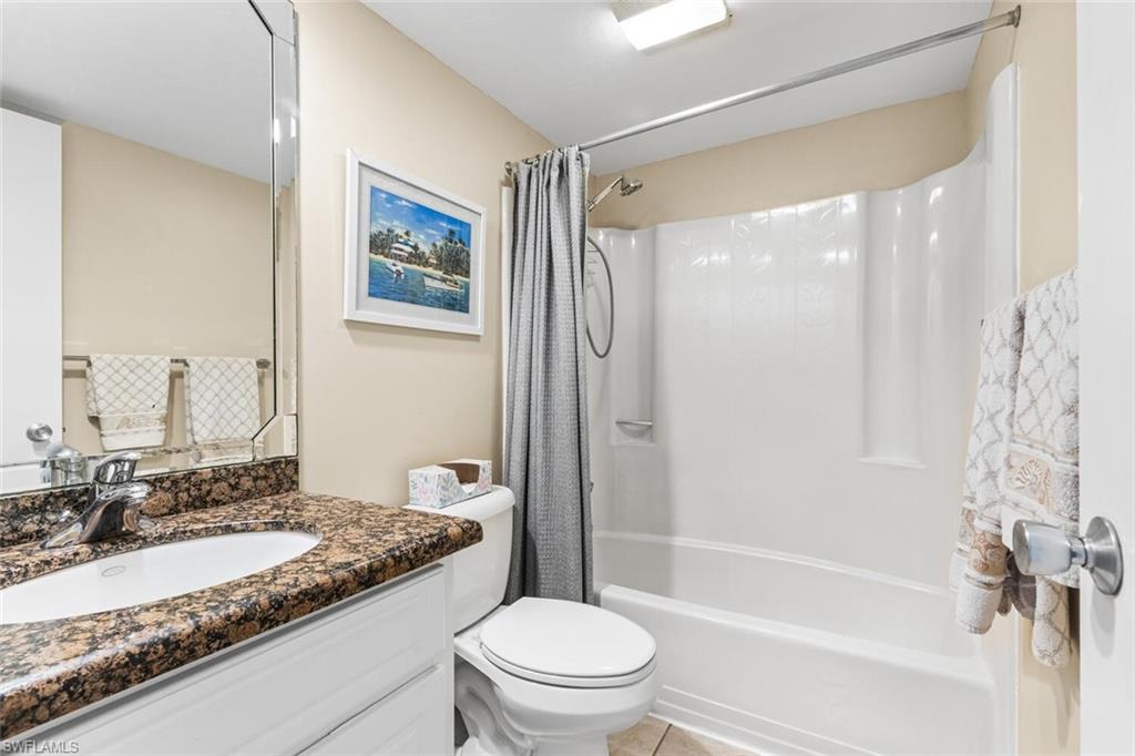1004 Manatee Road, Unit H306 Naples, FL 34114 - Photo 22 of 48 a bathroom with a granite countertop sink toilet and shower
