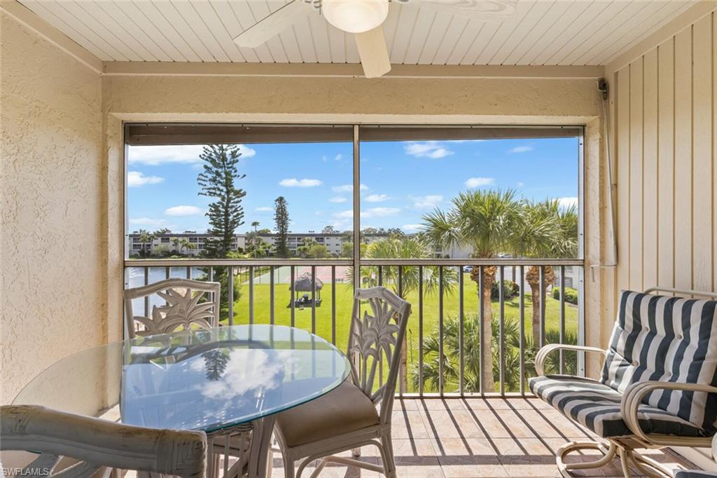 1004 Manatee Road, Unit H306 Naples, FL 34114 - Photo 23 of 48 a view of a balcony with chair and wooden floor