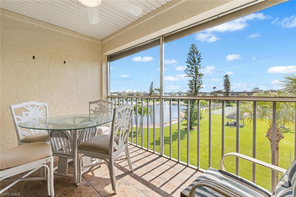 1004 Manatee Road, Unit H306 Naples, FL 34114 - Photo 24 of 48 a view of a balcony with furniture and a floor to ceiling window