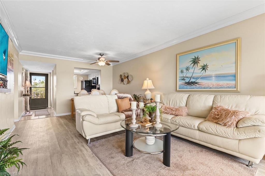 1004 Manatee Road, Unit H306 Naples, FL 34114 - Photo 3 of 48 a living room with furniture and wooden floor