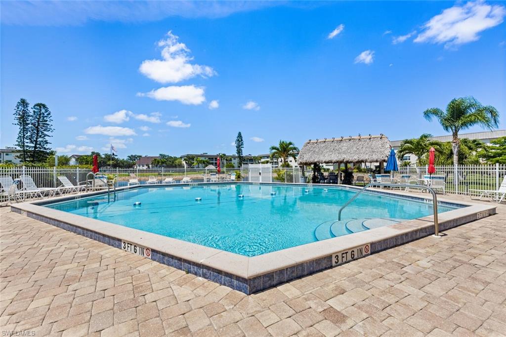 1004 Manatee Road, Unit H306 Naples, FL 34114 - Photo 37 of 48 a view of a swimming pool with a lounge chairs