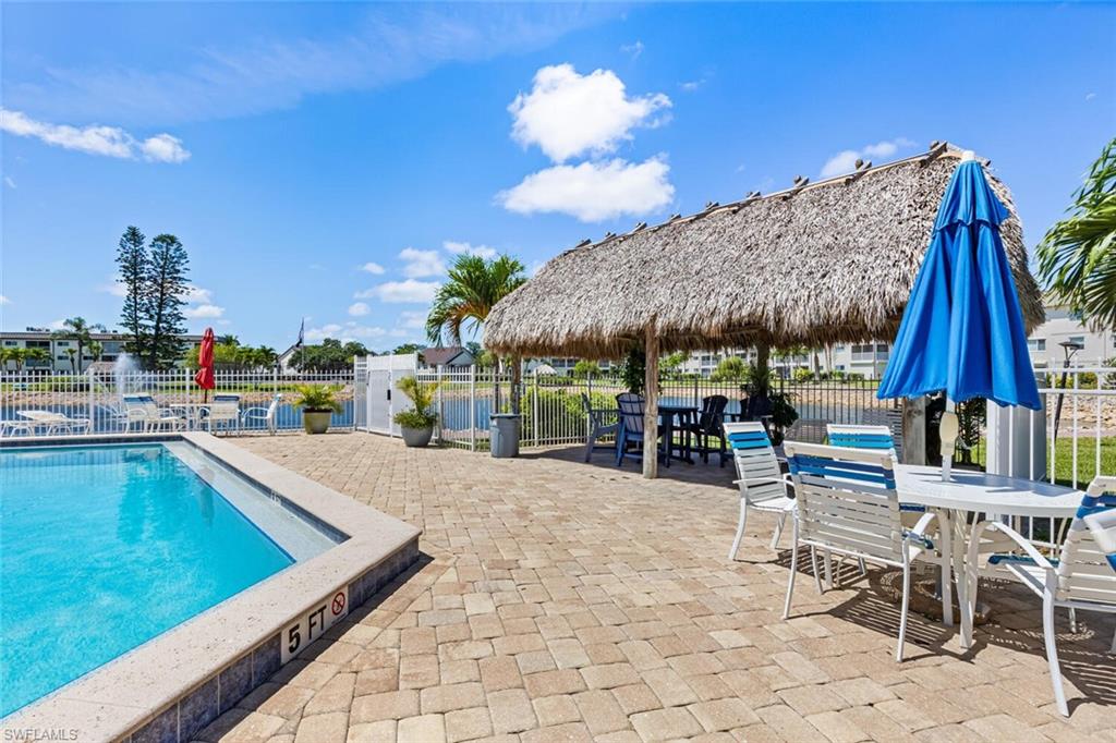 1004 Manatee Road, Unit H306 Naples, FL 34114 - Photo 39 of 48 a view of a swimming pool with a lounge chair