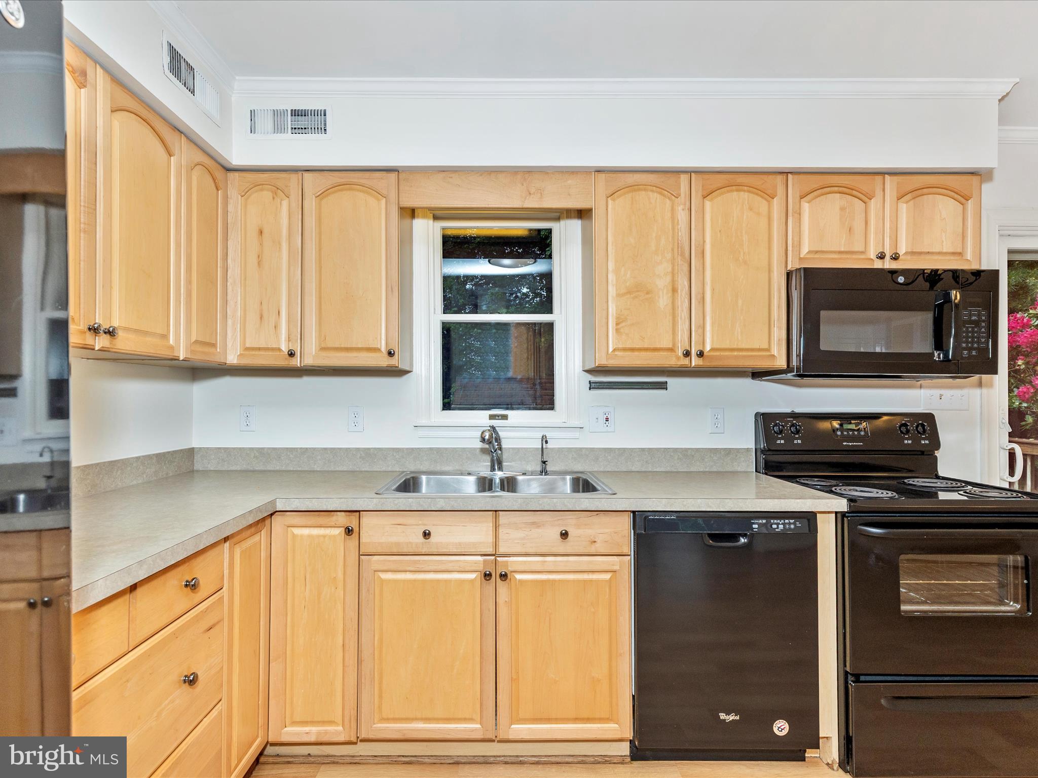 402 Windy Knoll Drive Mount Airy, MD 21771 - Photo 15 of 51 a kitchen with granite countertop a sink stainless steel appliances and cabinets