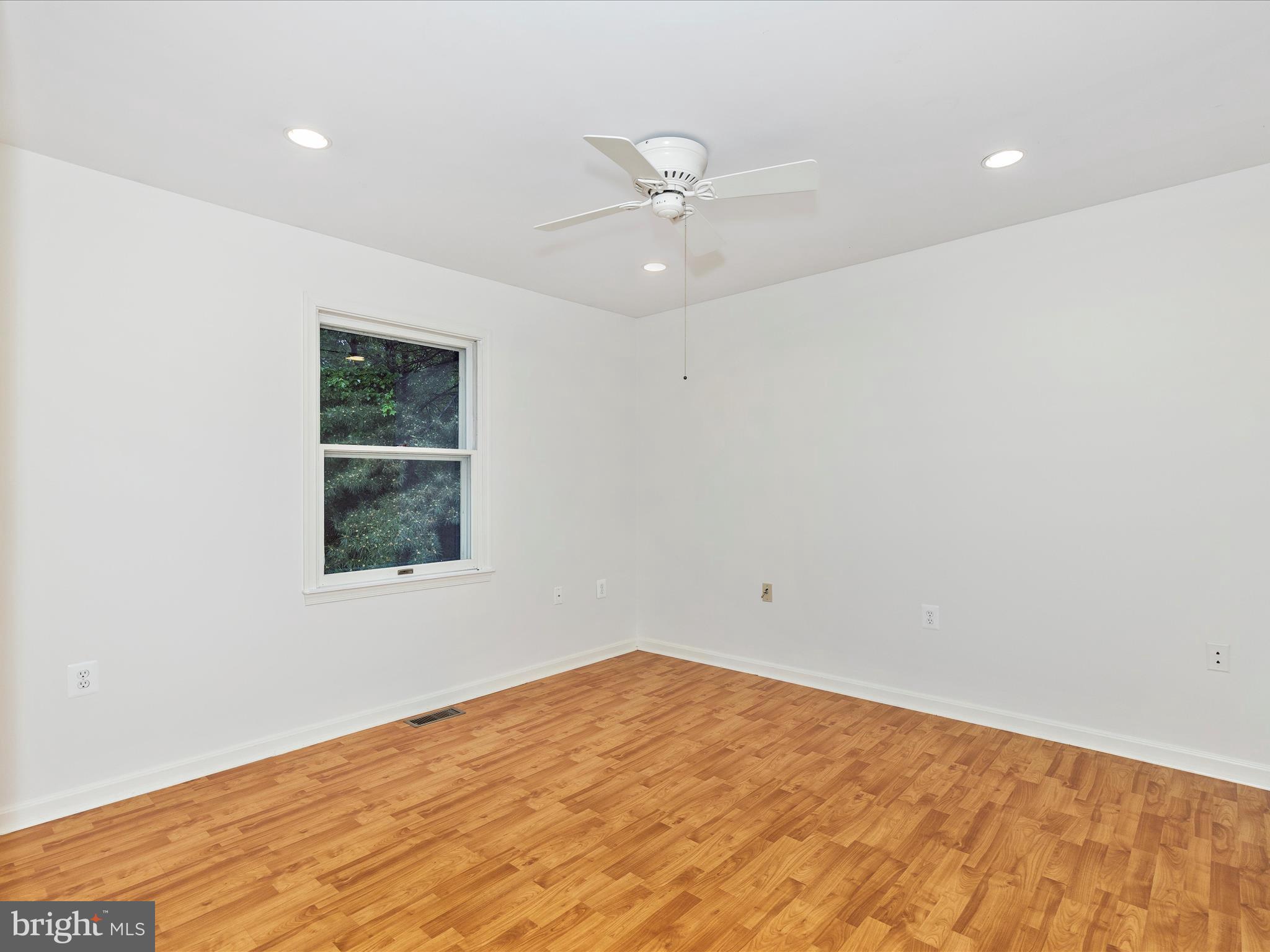 402 Windy Knoll Drive Mount Airy, MD 21771 - Photo 18 of 51 an empty room with a window and ceiling fan