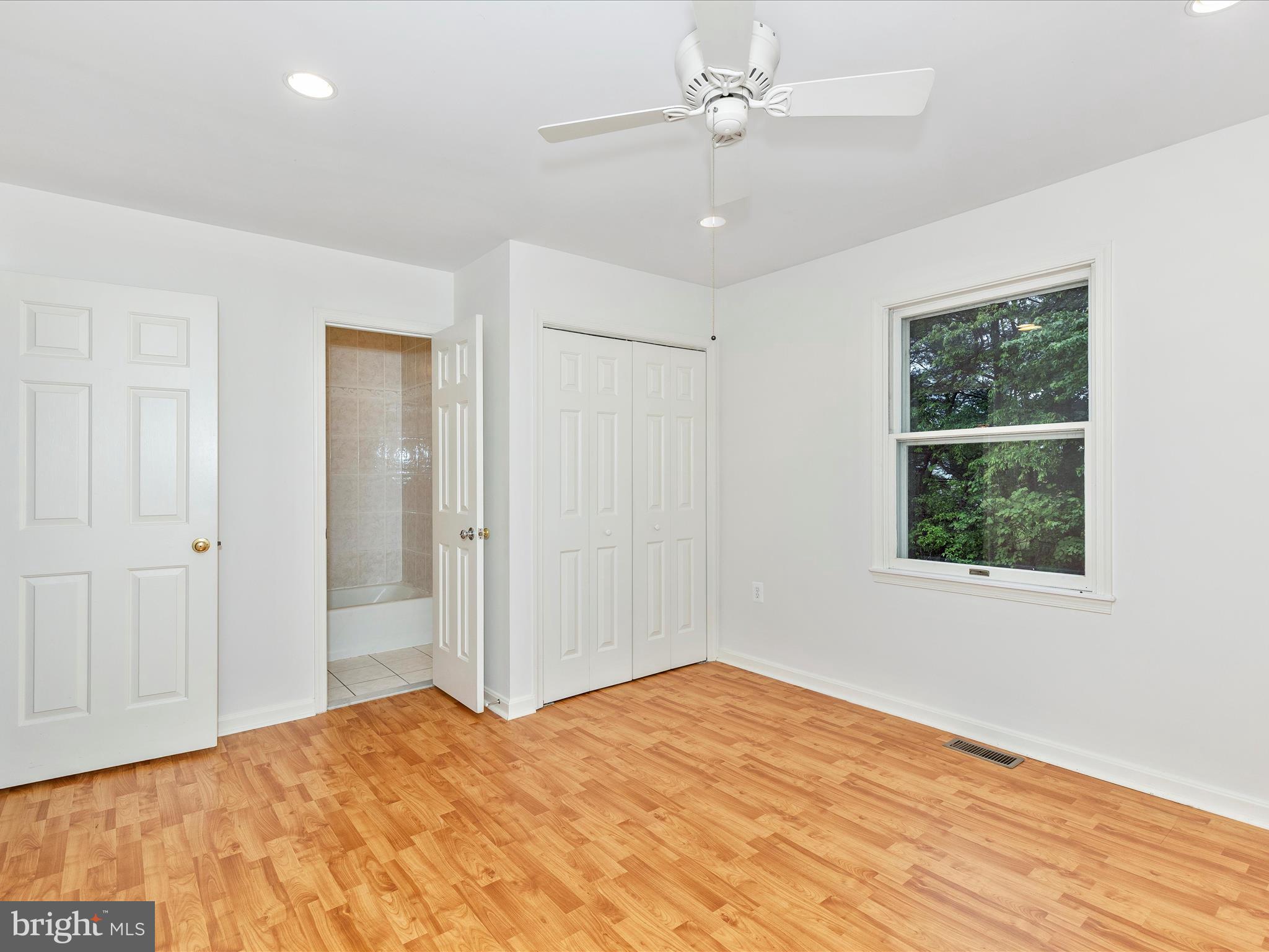 402 Windy Knoll Drive Mount Airy, MD 21771 - Photo 19 of 51 a view of an empty room with wooden floor and a window