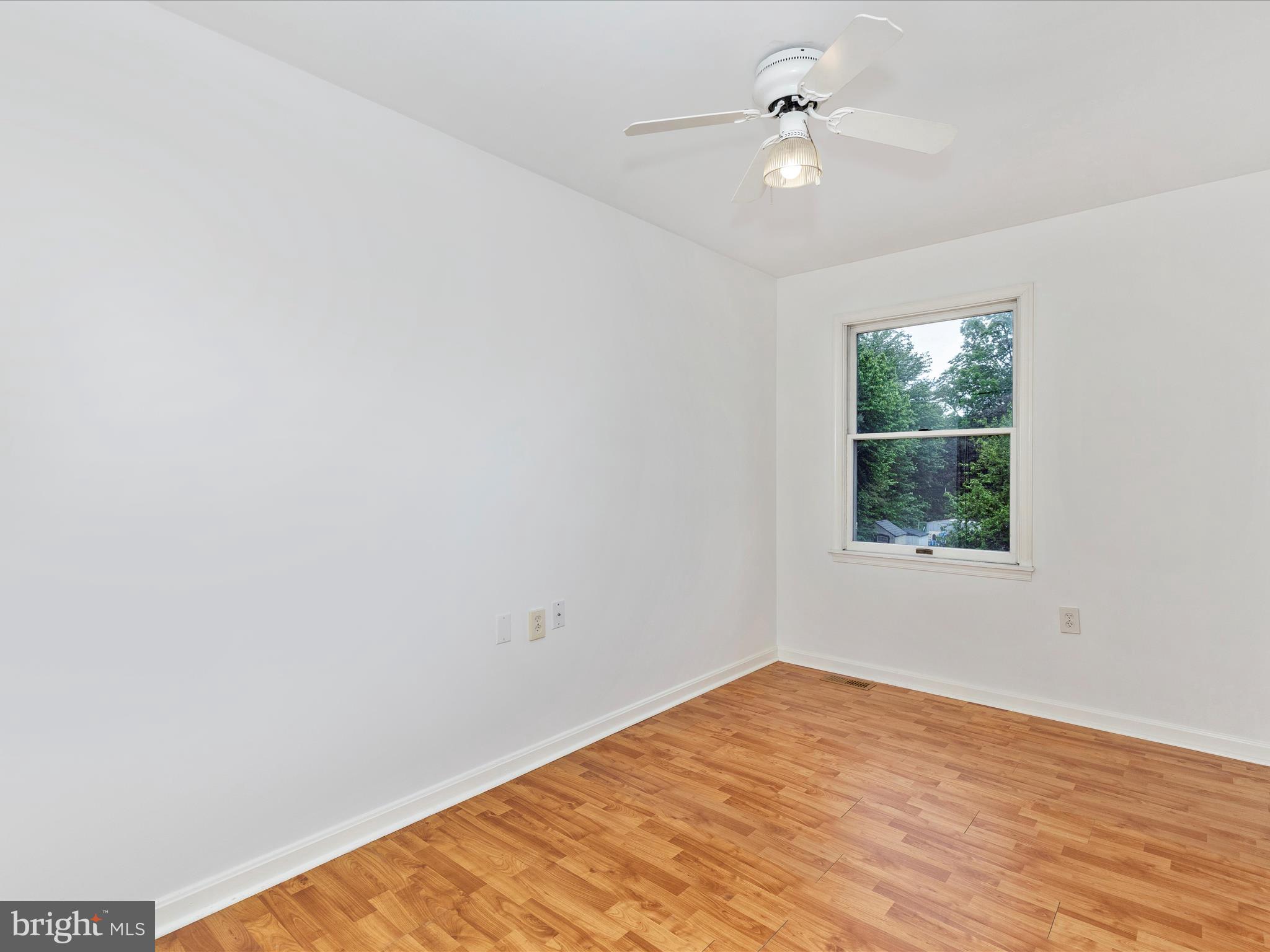 402 Windy Knoll Drive Mount Airy, MD 21771 - Photo 26 of 51 an empty room with a window and ceiling fan