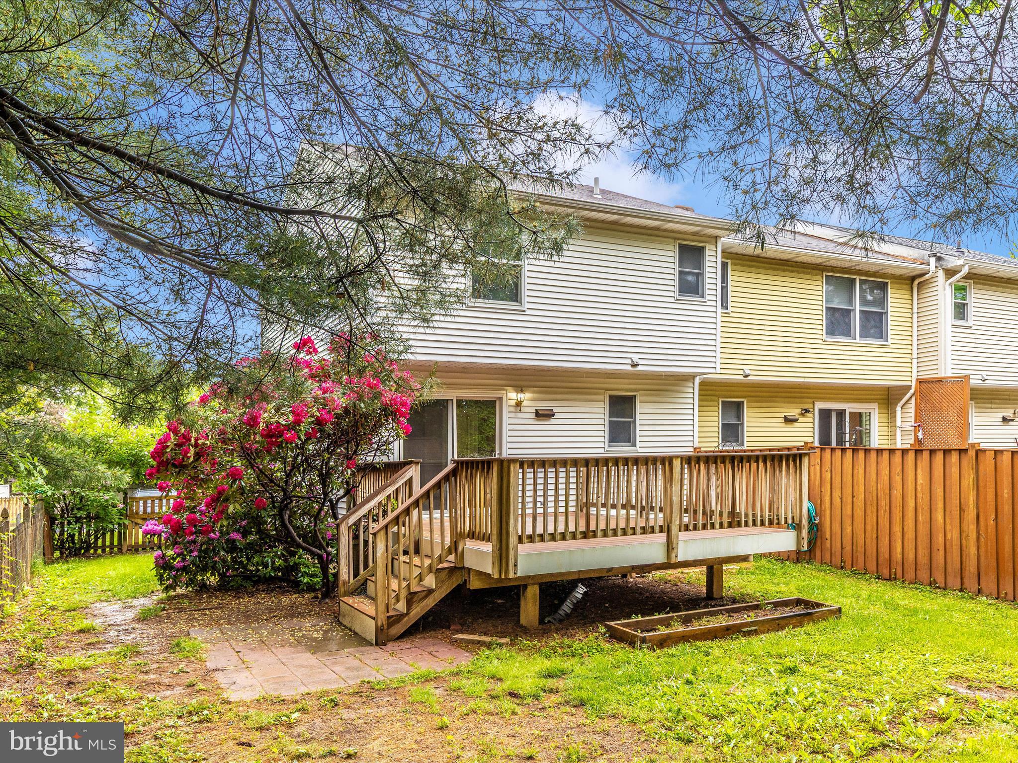 402 Windy Knoll Drive Mount Airy, MD 21771 - Photo 44 of 51 a view of a house with a wooden deck and a yard