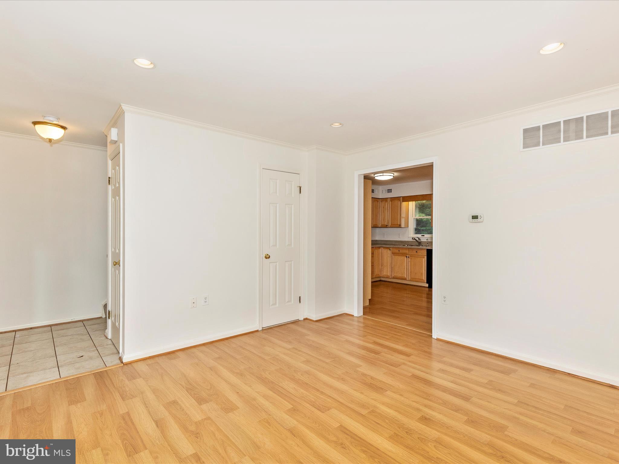 402 Windy Knoll Drive Mount Airy, MD 21771 - Photo 5 of 51 a view of an empty room with wooden floor and closet
