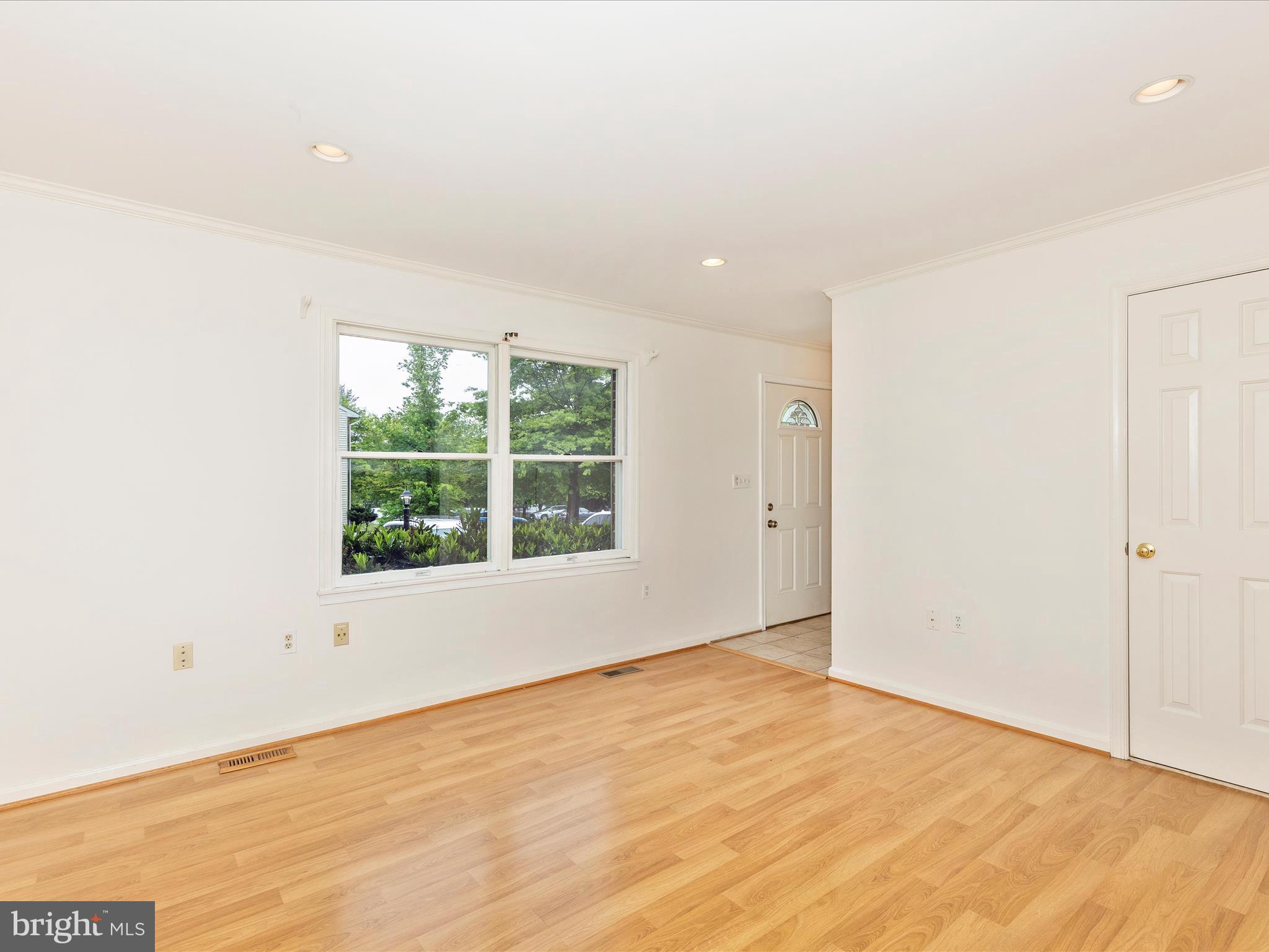 402 Windy Knoll Drive Mount Airy, MD 21771 - Photo 6 of 51 an empty room with wooden floor and windows