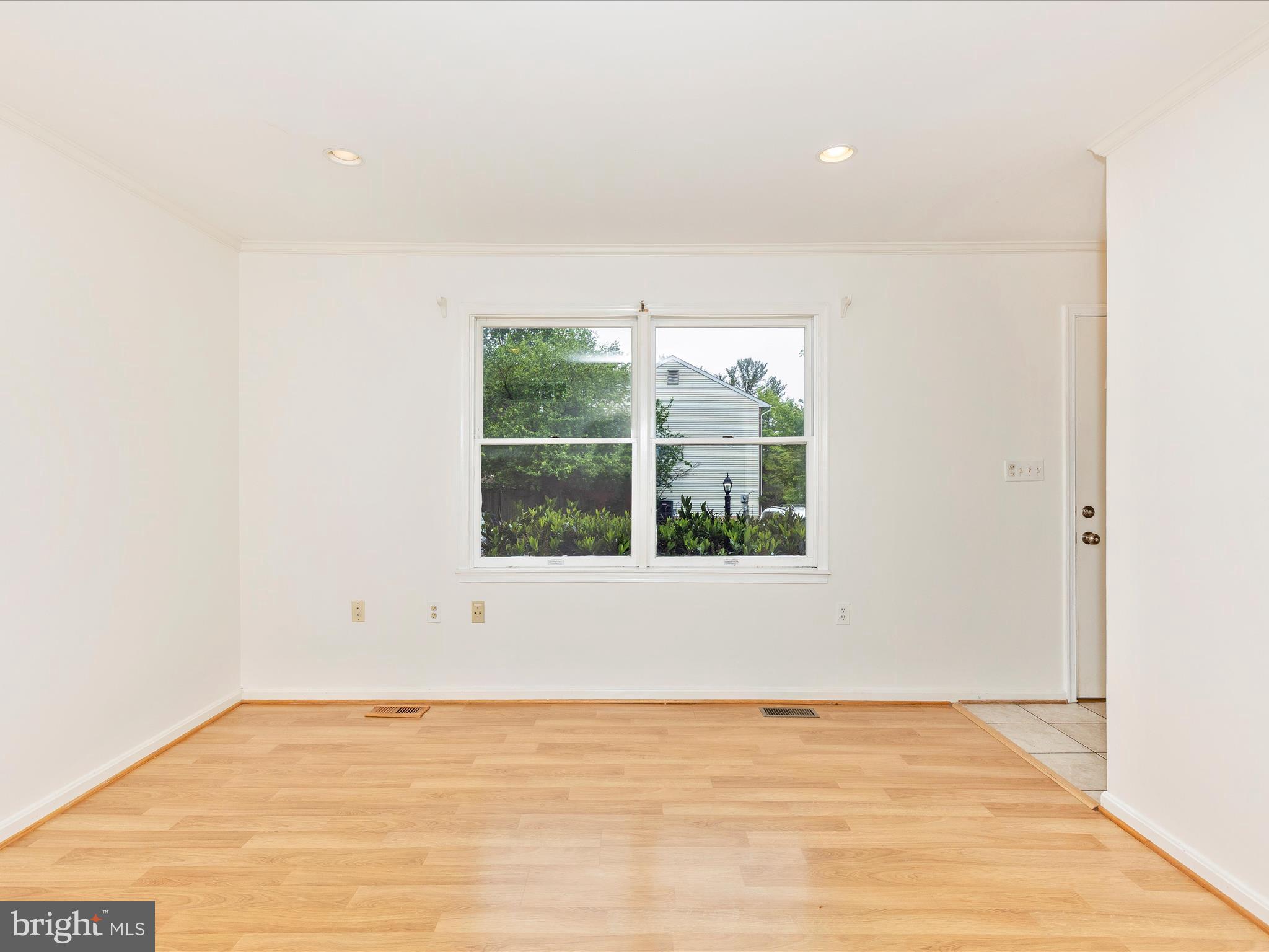 402 Windy Knoll Drive Mount Airy, MD 21771 - Photo 7 of 51 a view of an empty room with wooden floor and a window