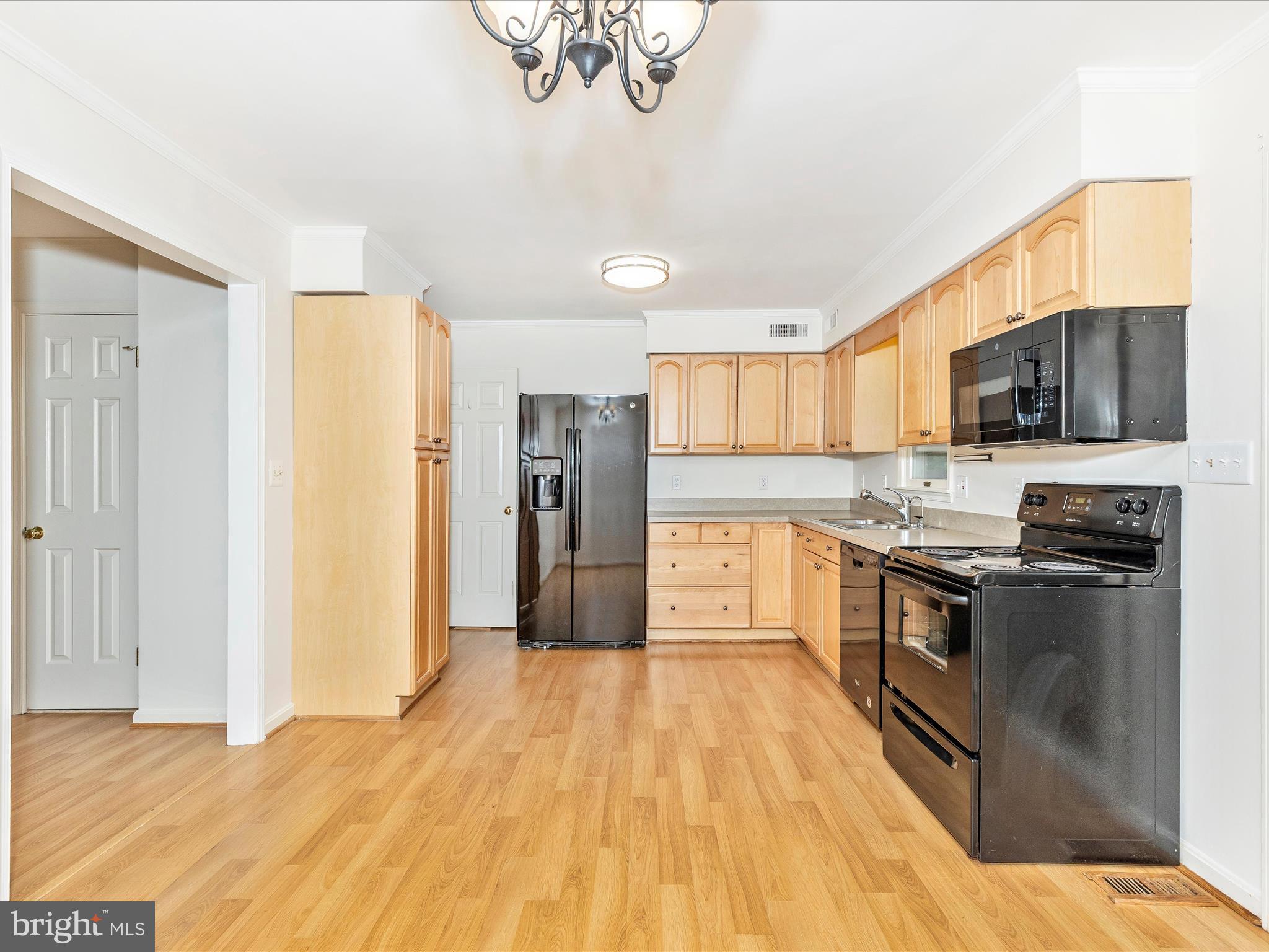 402 Windy Knoll Drive Mount Airy, MD 21771 - Photo 10 of 51 a kitchen with stainless steel appliances granite countertop a refrigerator a stove top oven a sink dishwasher and a refrigerator with wooden floor