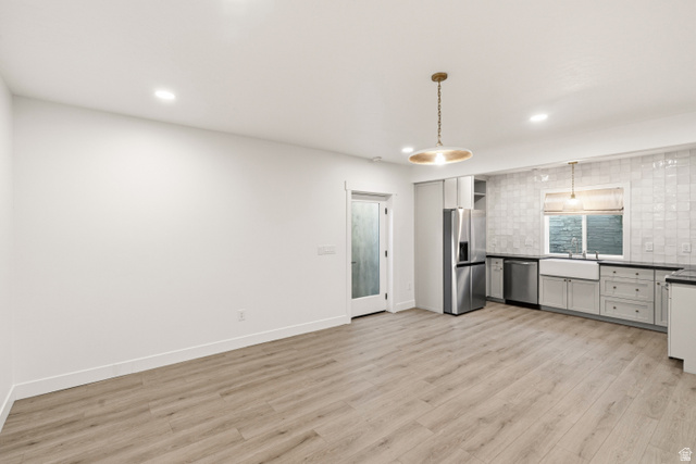 870 North Ada Loop Lehi, UT 84048 - Photo 38 of 51 Open-concept living area featuring light wood-finish flooring, recessed lighting, and a modern kitchen