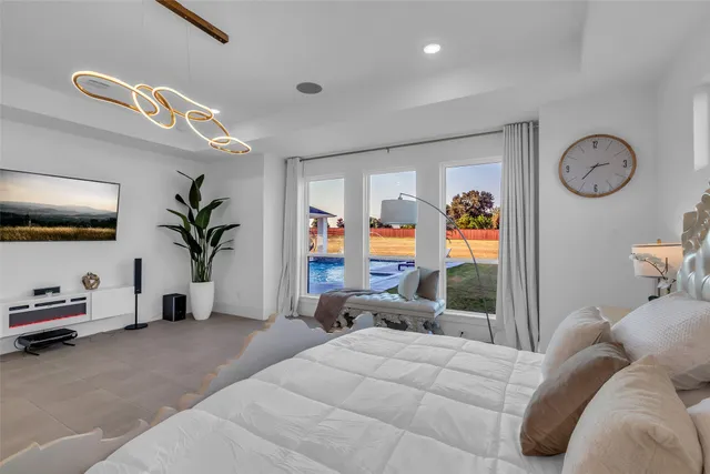 a bedroom with furniture and a large window