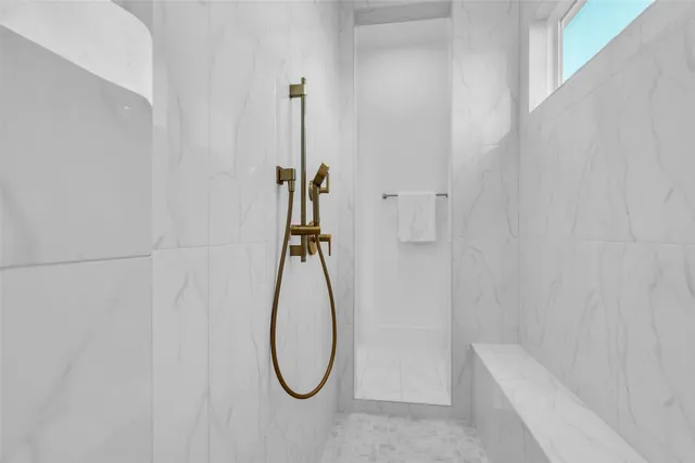 a bathroom with a shower and a shower