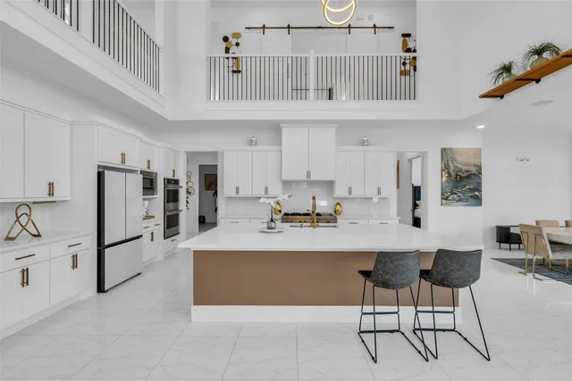 a living room with stainless steel appliances kitchen island granite countertop furniture and a kitchen view