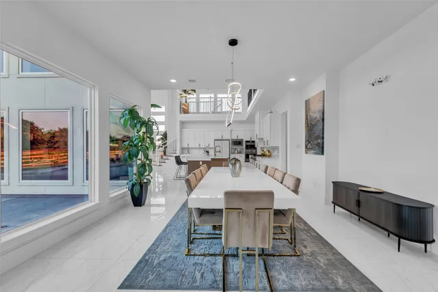 a view of a dining room with furniture and a potted plant