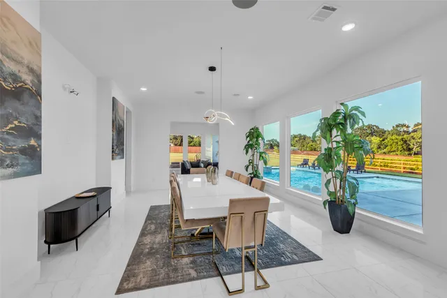a dining room with furniture and a potted plant
