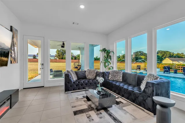 a living room with furniture and a large window