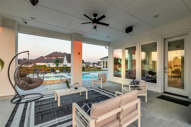 a living room with furniture and a floor to ceiling window