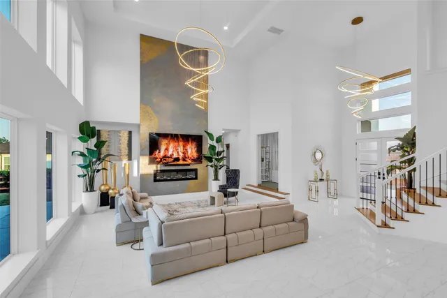 a living room with furniture flat screen tv and a potted plant