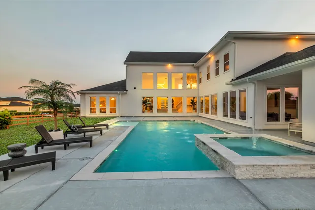 a swimming pool with outdoor seating and yard