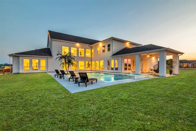 a view of a house with a backyard porch and sitting area