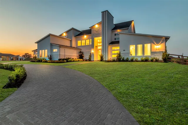 a front view of a house with a garden and yard