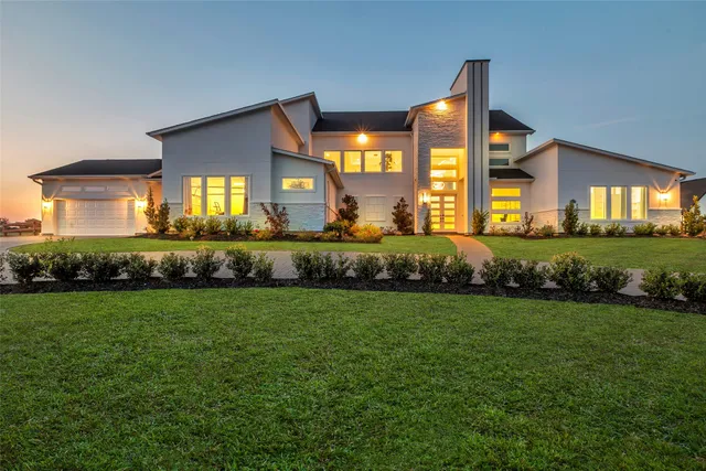 a front view of a house with a garden and patio