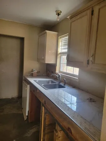 a kitchen with a sink and a refrigerator